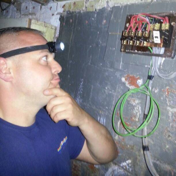 Qualified electrician inspecting hidden wiring in Leeds home
